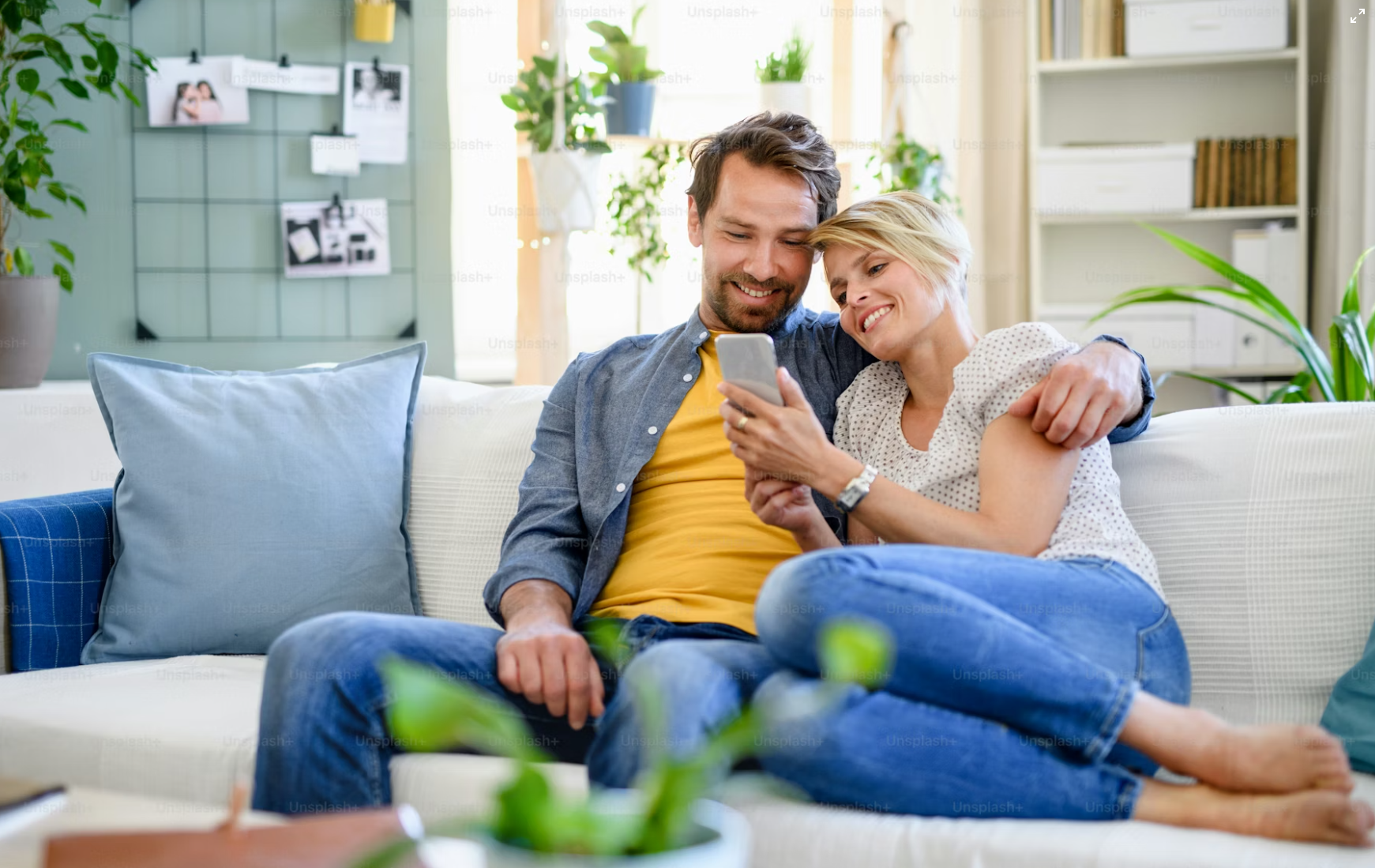 Happy couple looking at smartphone